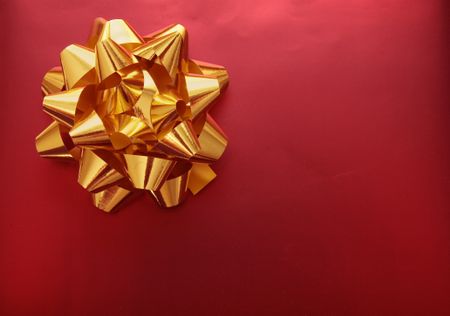 golden ribbon on a red gift