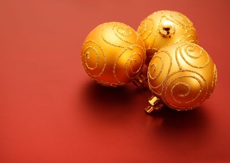 golden christmas balls on a red background