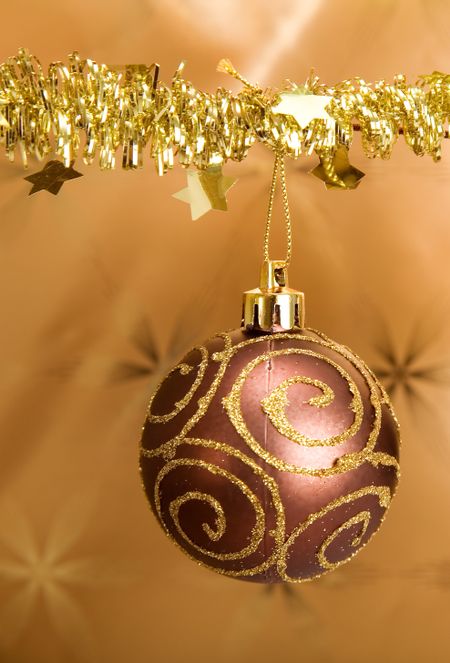 christmas bauble hanging on a golden background