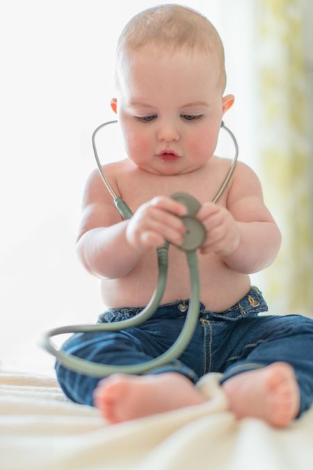 Cute baby listening to a stethoscope