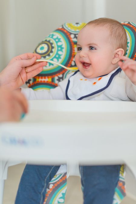 Cute baby eating puree