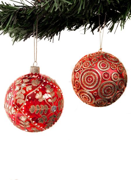 christmas balls hanging from a xmas tree over a white background