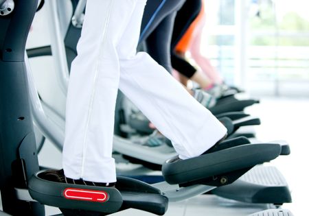 side view of people legs while exercising on the xtrainer