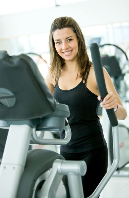 beautiful woman at the gym exercising in the cardio machines