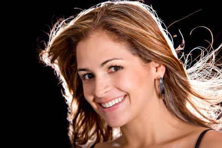 gorgeous woman portrait smiling isolated over a black background