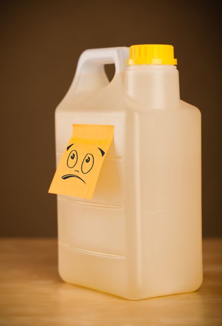 Drawn smiley face on a post-it note sticked on can