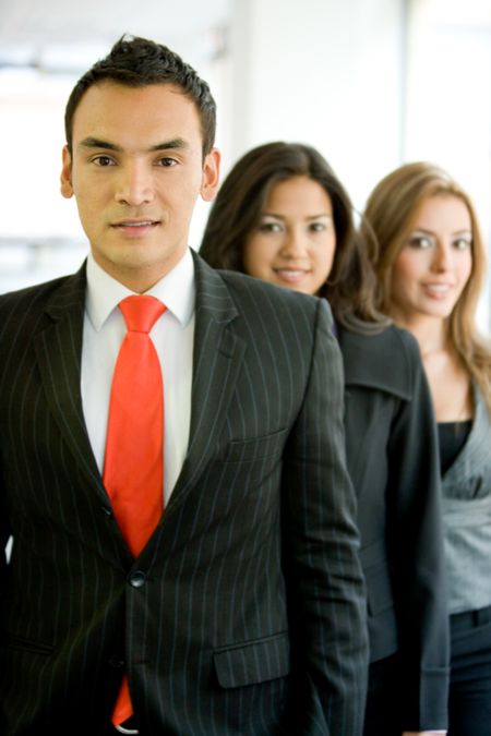 business man smiling leading his team in an office
