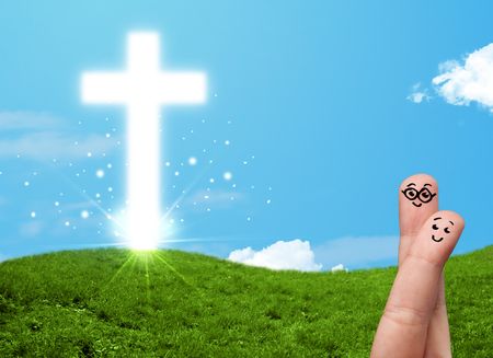 Happy finger smiley faces on hand with christian religion cross