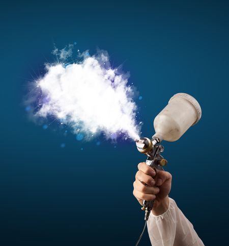 Painter with airbrush gun and white magical smoke concept