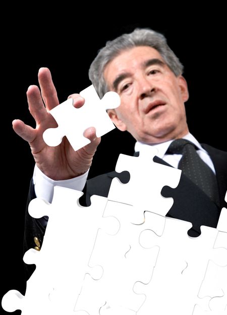 business man solving a puzzle over a black background