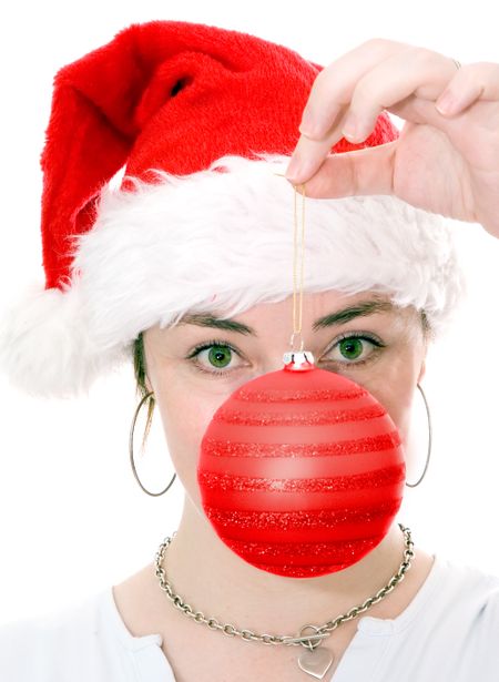 female santa claus holding a bauble in front of her face