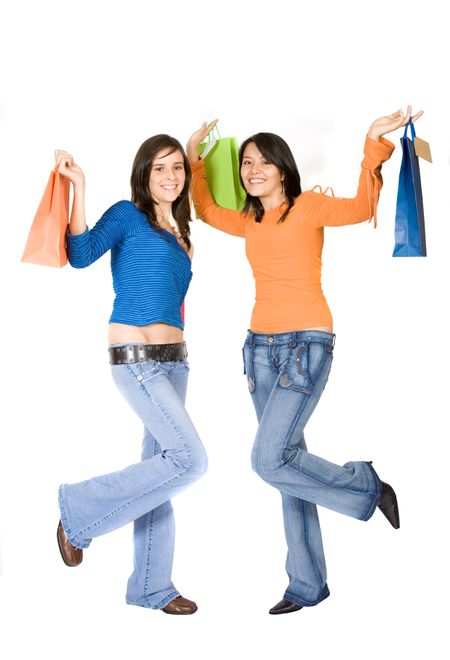 girls having fun on a shopping day out - they are carrying shopping bags with happy expressions on their faces over a white background