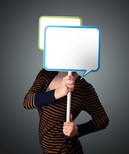 Young lady standing and holding an empty speech bubble in front of her head