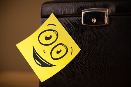 Drawn smiley face on a note sticked on a jewelry box