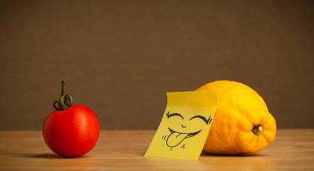 Lemon with sticky post-it note gesturing with tongue to tomato