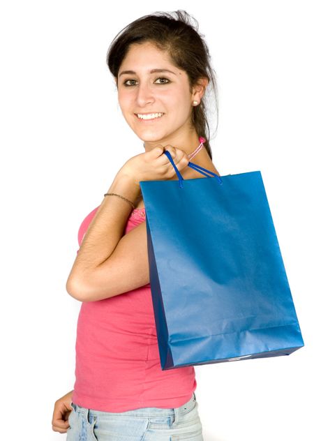 beautiful teenager with shopping bags over white