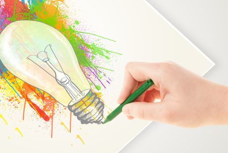 Hand drawing on a plain paper a colorful splatter lightbulb
