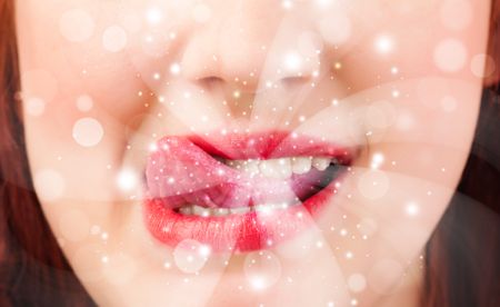 pretty-woman-lips-blowing-abstract-white-225889540 Pretty woman lips blowing abstract white lights - close up