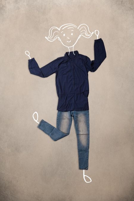 Colorful placed clothes in different actions with woman drawing