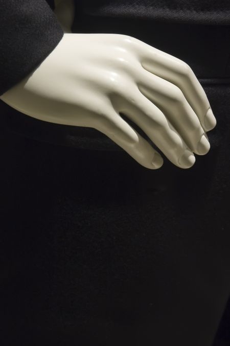 Cuffed hand of male mannikin in store window