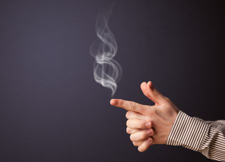 Gun shaped man hand with smoke