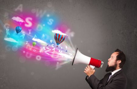 Handsome man shouting into megaphone and abstract text and balloons come out