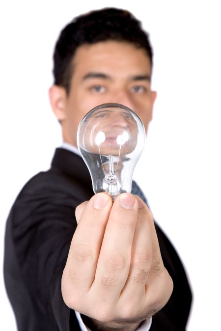 business man holding a lightbulb over white - narrow dof with focus on hand