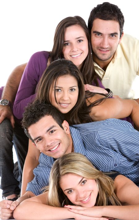 Happy group of friends with their heads together on the floor isolated over a white background