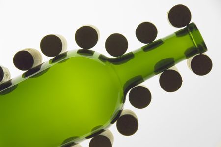 Green wine bottle flanked by corks