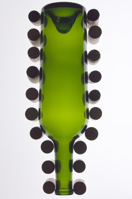 Empty wine bottle surrounded by corks