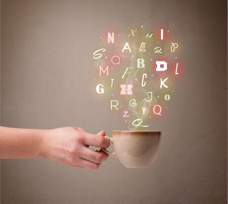 Coffee cup with colorful letters, close up