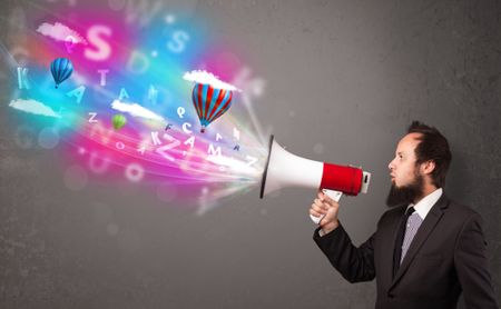 Handsome man shouting into megaphone and abstract text and balloons come out