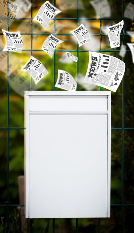 Post box with daily newspapers flying out