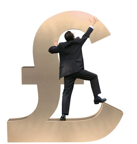 business man climbing a british pound sign
