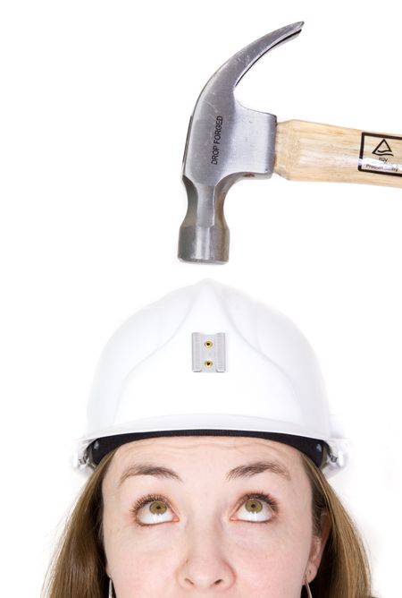 girl with safety helmet about to be hit by a hammer over a white background