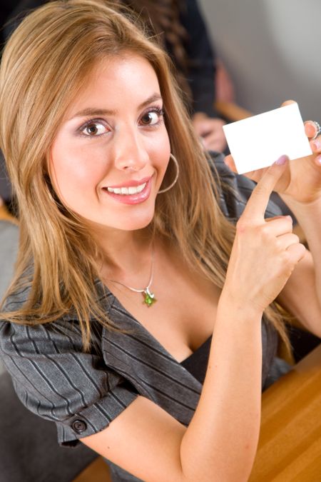 businesswoman pointing at a business card in an office