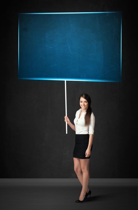 Young businesswoman holding a big, blue board 