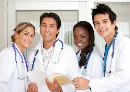 small group of doctors standing together in a hospital room