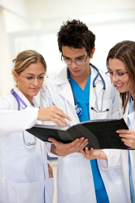 small group of doctors discussing a medical history in a hospital