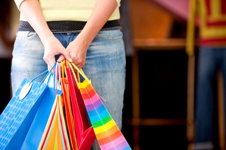 casual woman carrying shopping bags in a store