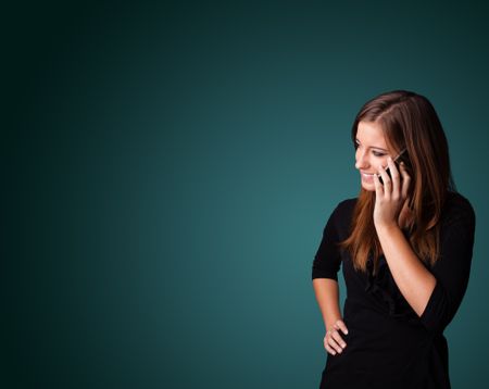 Young woman standing and making phone call with copy space