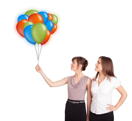 Beautiful young women holding colorful balloons