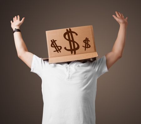 Young man standing and gesturing with a cardboard box on his head with dollar signs