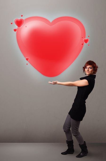 Beautiful young lady holding lovely 3d red heart