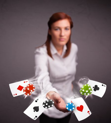 Pretty young woman playing with poker cards and chips 