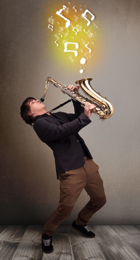 Handsome young musician playing on saxophone with musical notes