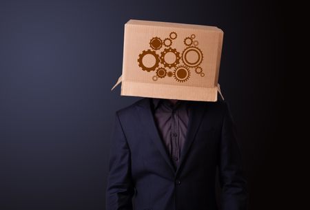 Young man standing and gesturing with a cardboard box on his head with spur wheels