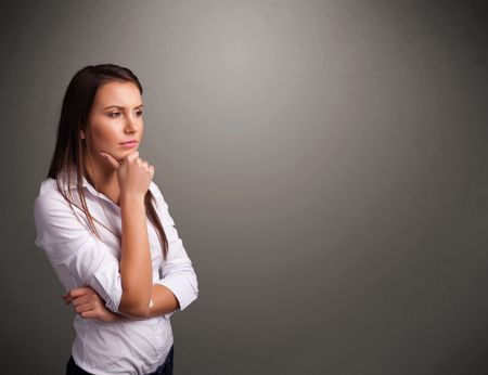 Beautiful young woman thinking with empty copy space