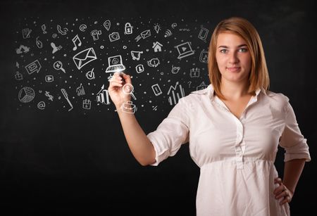 Young woman drawing and sketching icons and symbols on white background