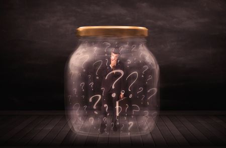 Businessman locked into a jar with question marks concept on background